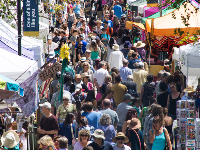 The quad packed with people walking through where the vendors set up.